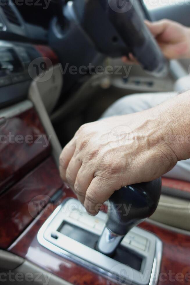Hand gripping gear shift while driving in a modern vehicle photo