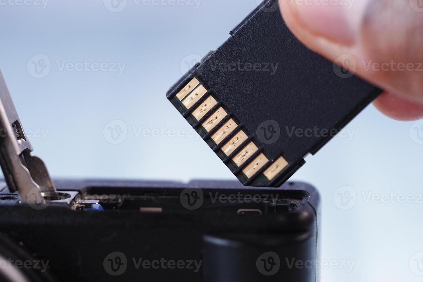 Removing memory card from a digital camera for data transfer photo