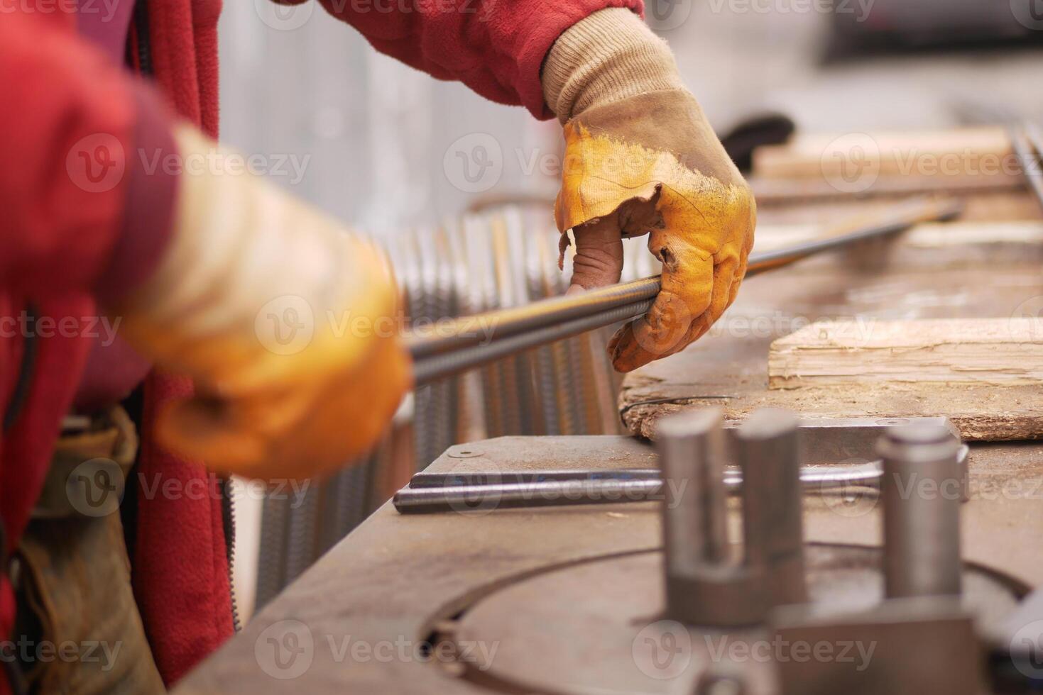 Crafting metal rods in a workshop during daylight hours photo