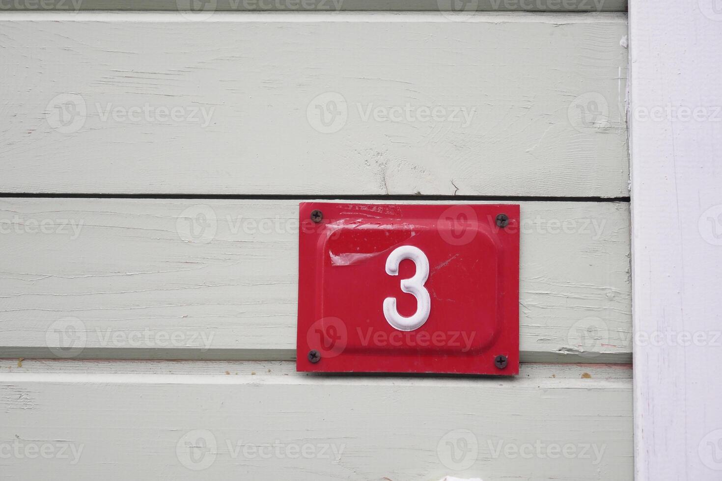 Number three displayed on a rustic wooden wall panel photo