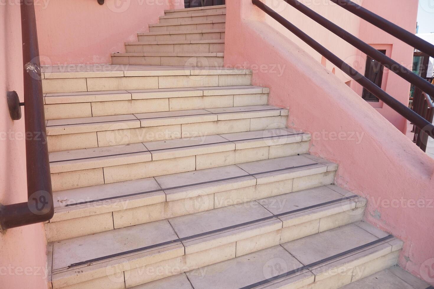 Steps leading to a vibrant building in a sunny location photo
