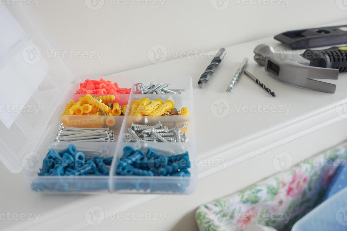 Tool organization with colorful fasteners and drill bits on shelf photo