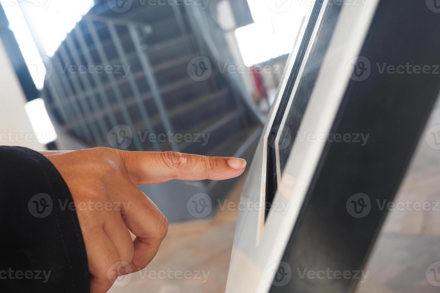 User interacting with digital touchscreen at a modern facility photo