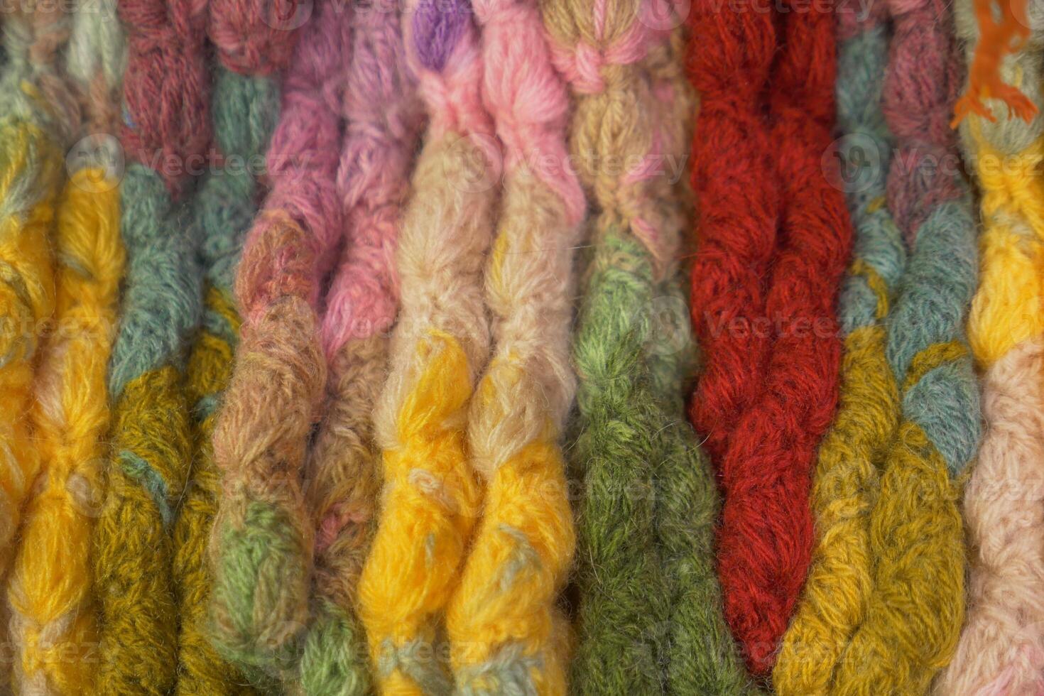 Colorful yarn strands displayed in a craft workshop setting photo