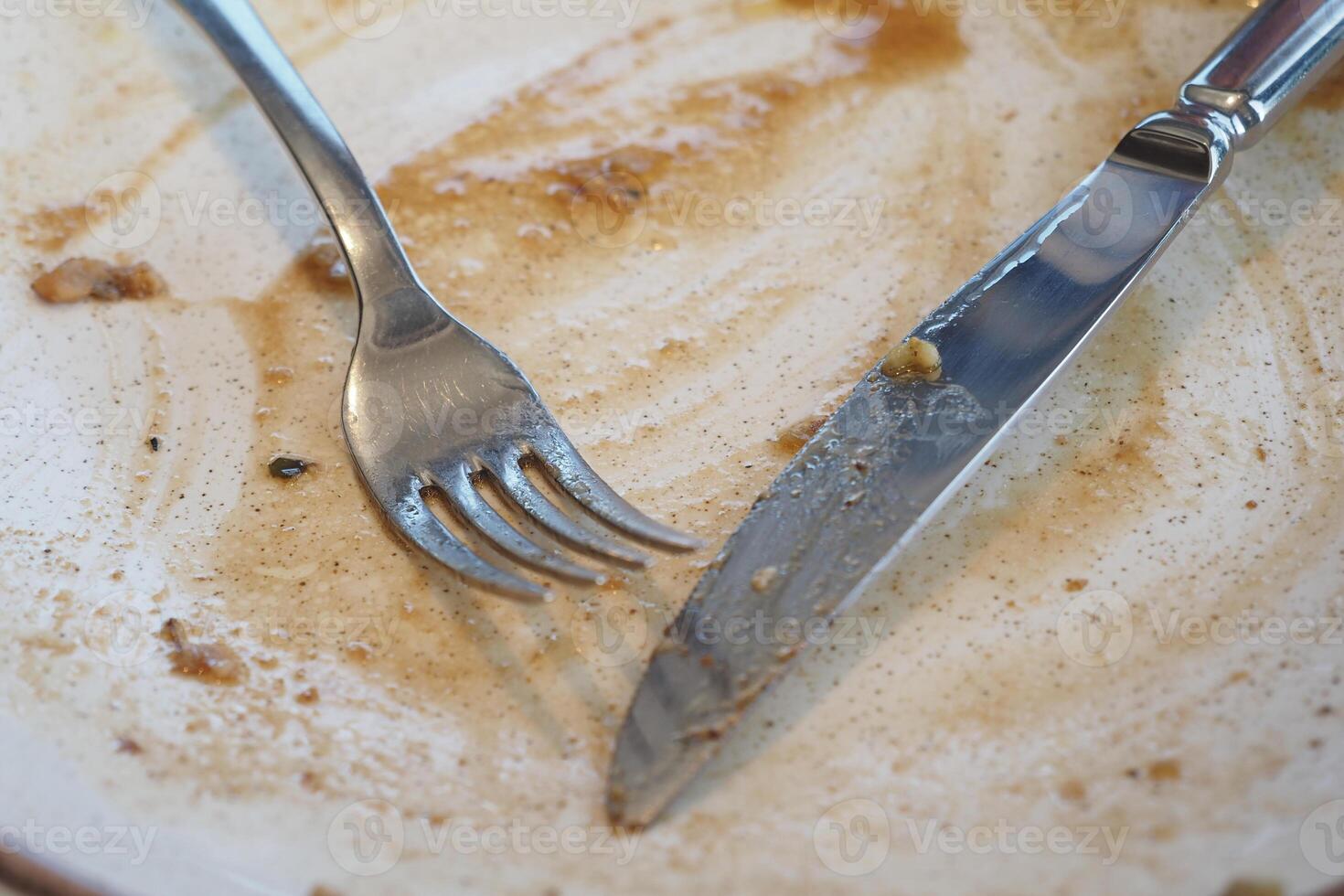 Enjoyed meal leaves empty plate with cutlery at restaurant table photo