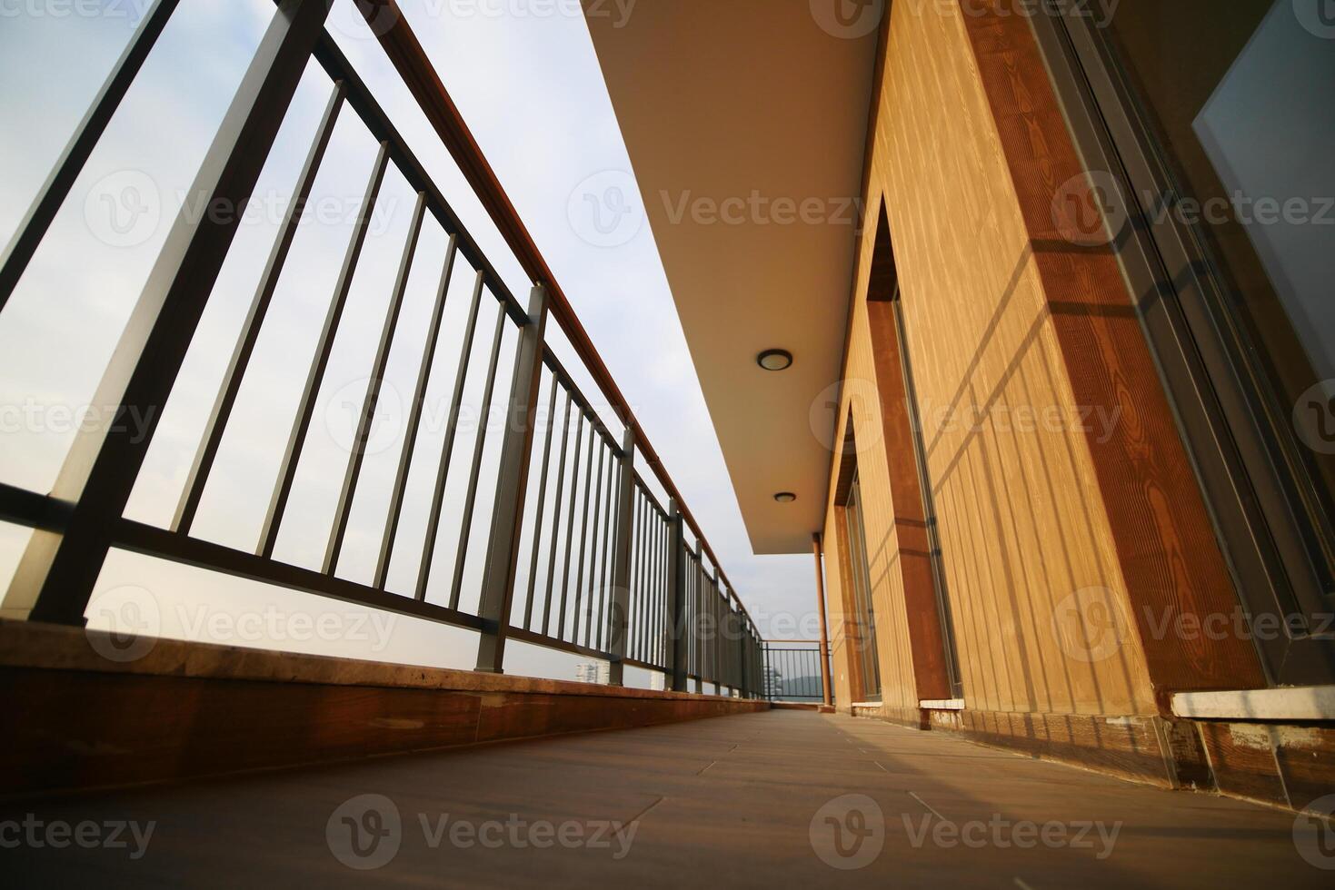 View from a modern balcony overlooking a scenic landscape at dusk photo