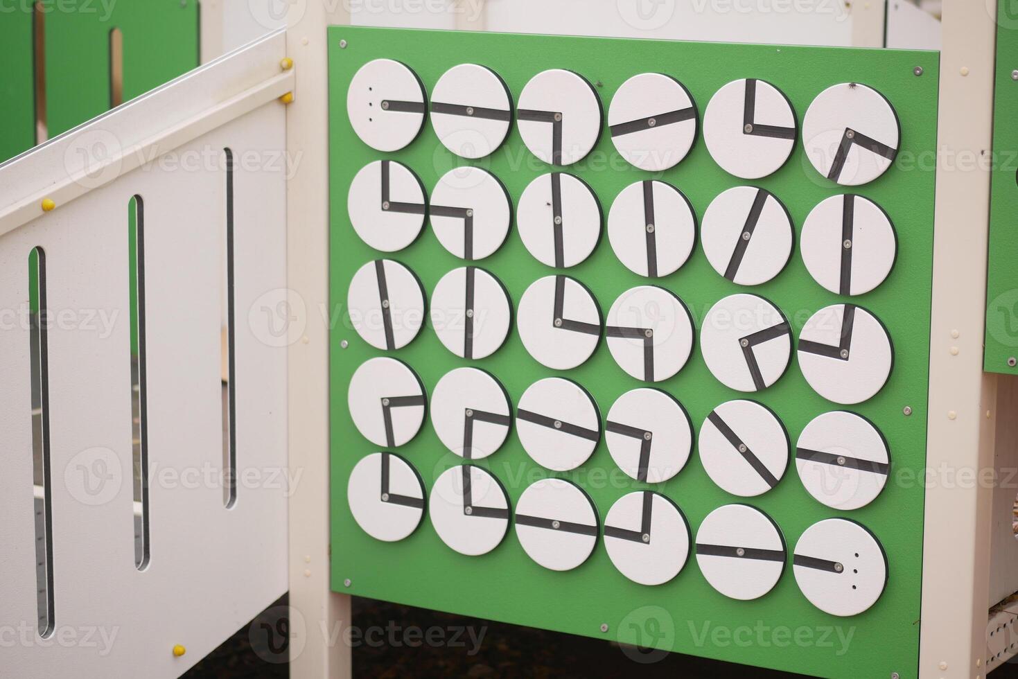 Children engage with interactive clock display in playground photo