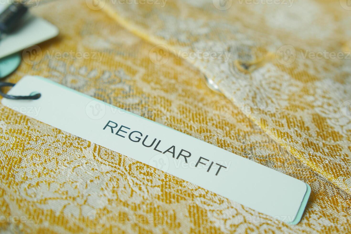 Label indicating regular fit on a lace garment displayed for sale photo