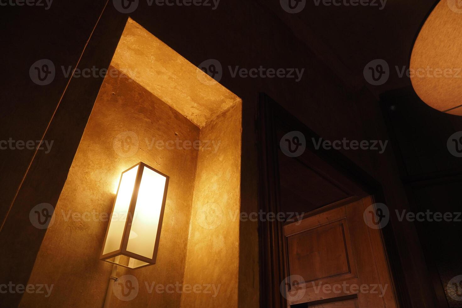 Soft lighting in a cozy corner of a dimly lit room photo