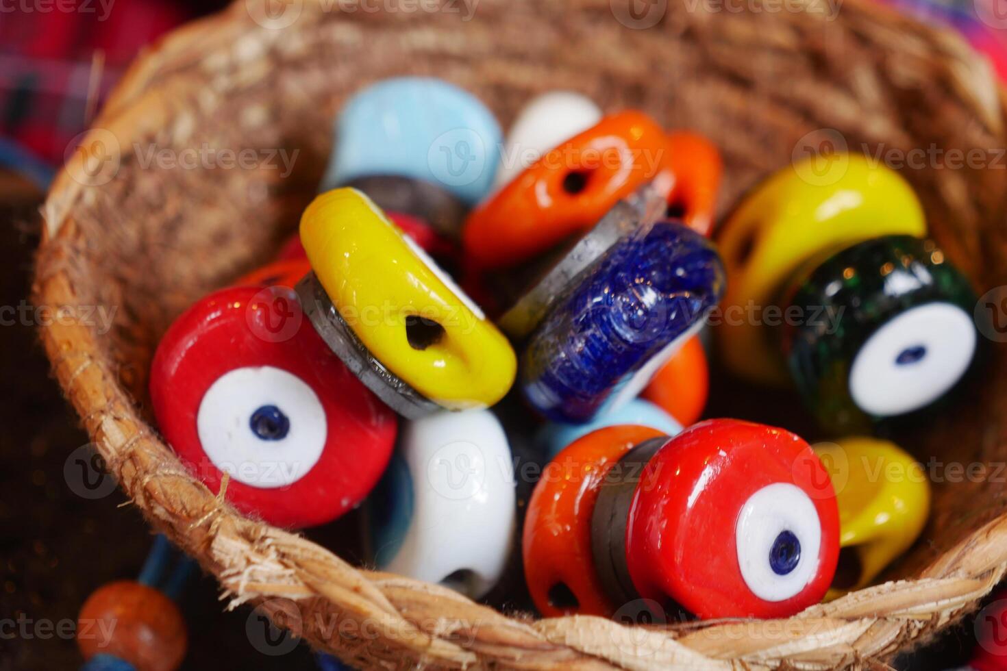 Colorful handmade ceramic beads in a woven basket photo