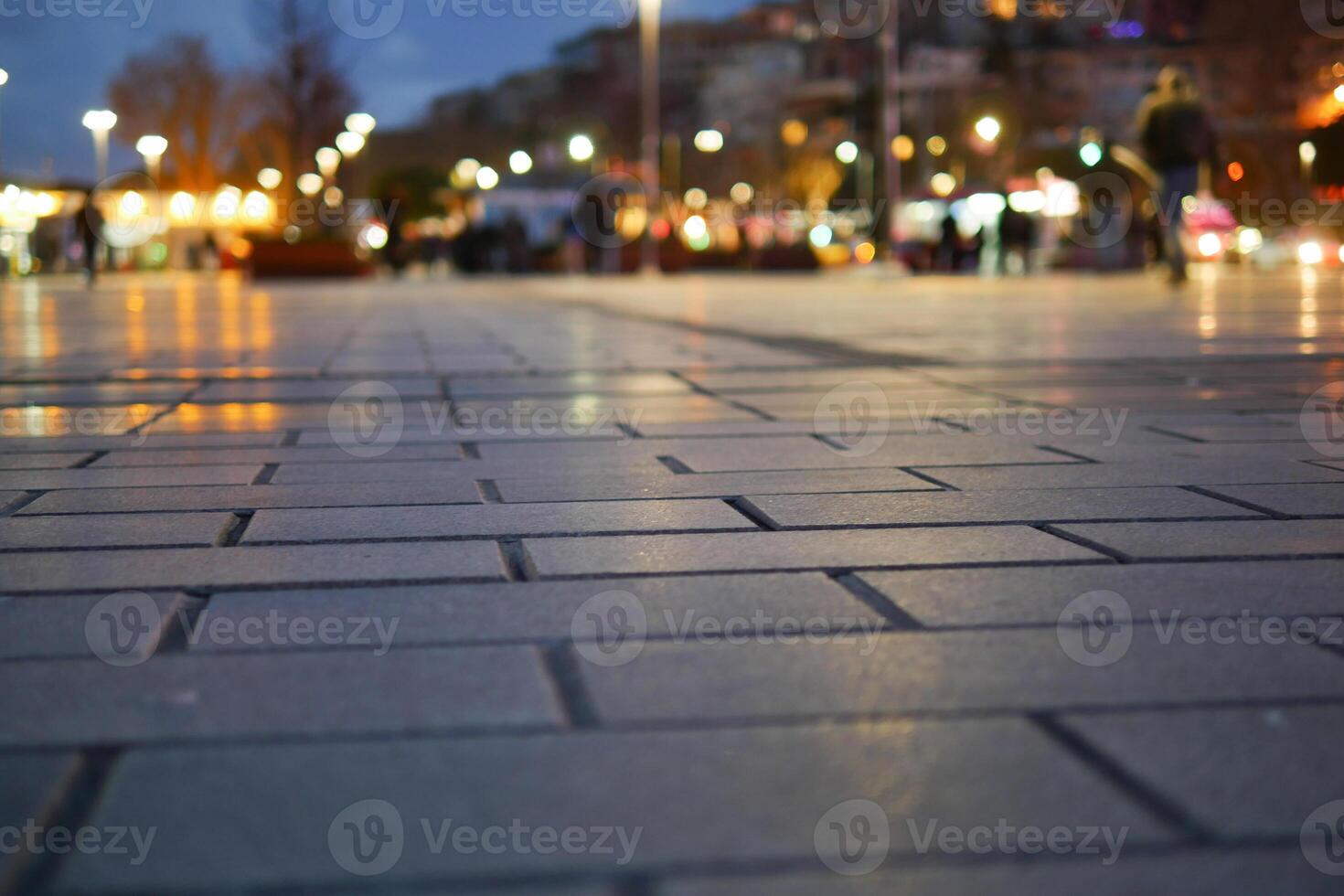 Evening walk on the illuminated city pavement at dusk photo