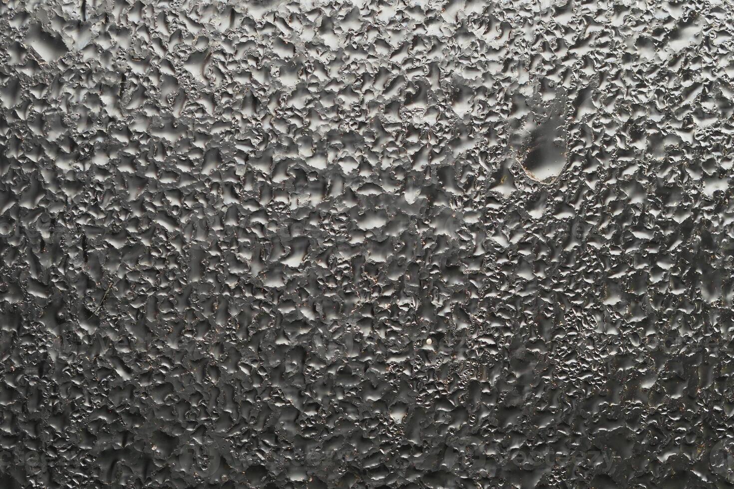 Close-up view of raindrops on a window during a rainstorm photo