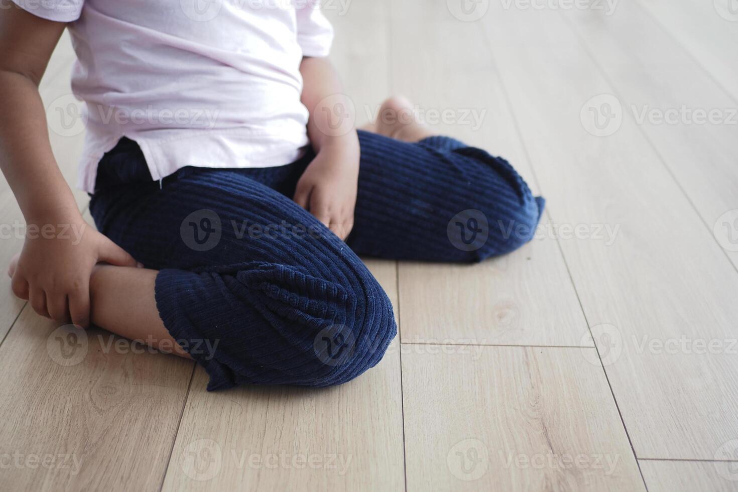 Cerebral palsy child sitting with w shape photo