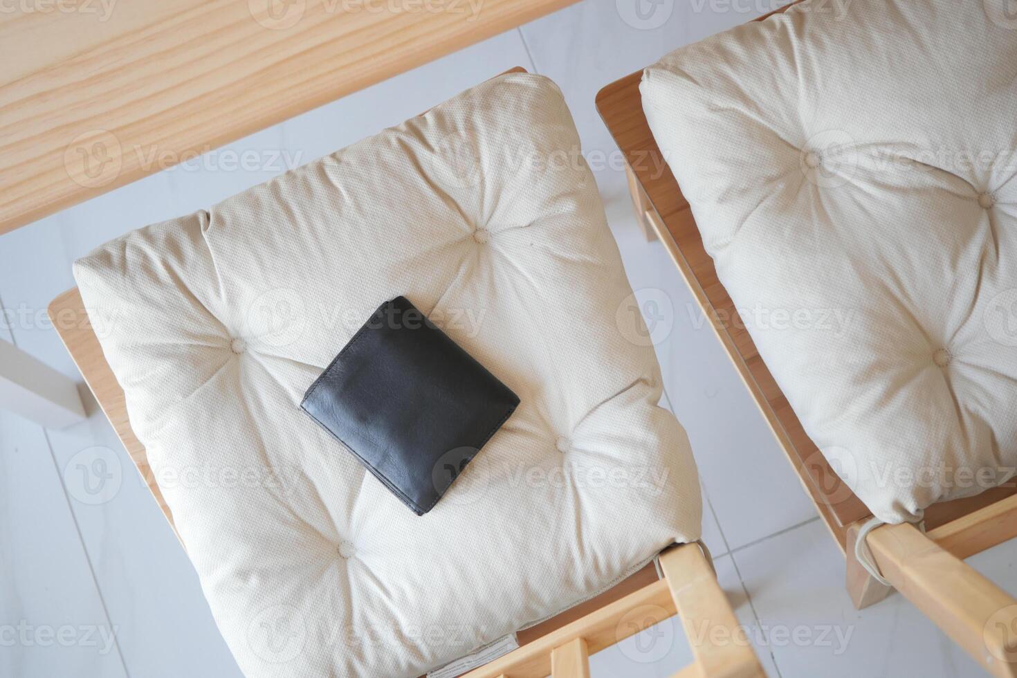 Black wallet placed on a cushioned chair. lost wallet concept photo