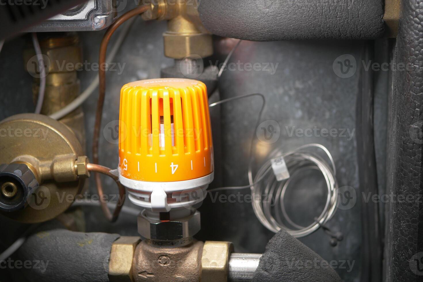 Equipment control valve with orange knob located in mechanical room photo