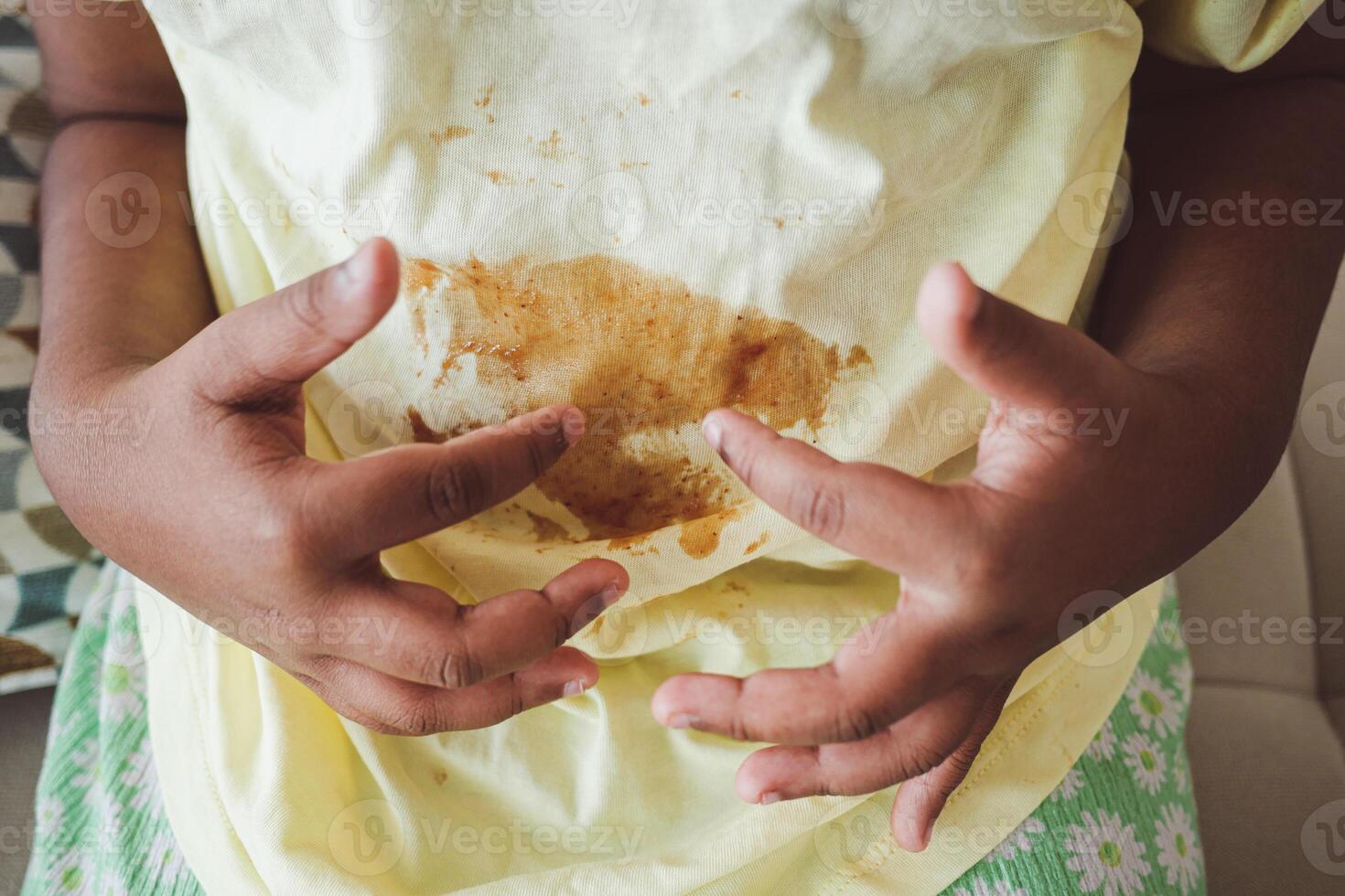 Child with messy shirt after eating snacks photo