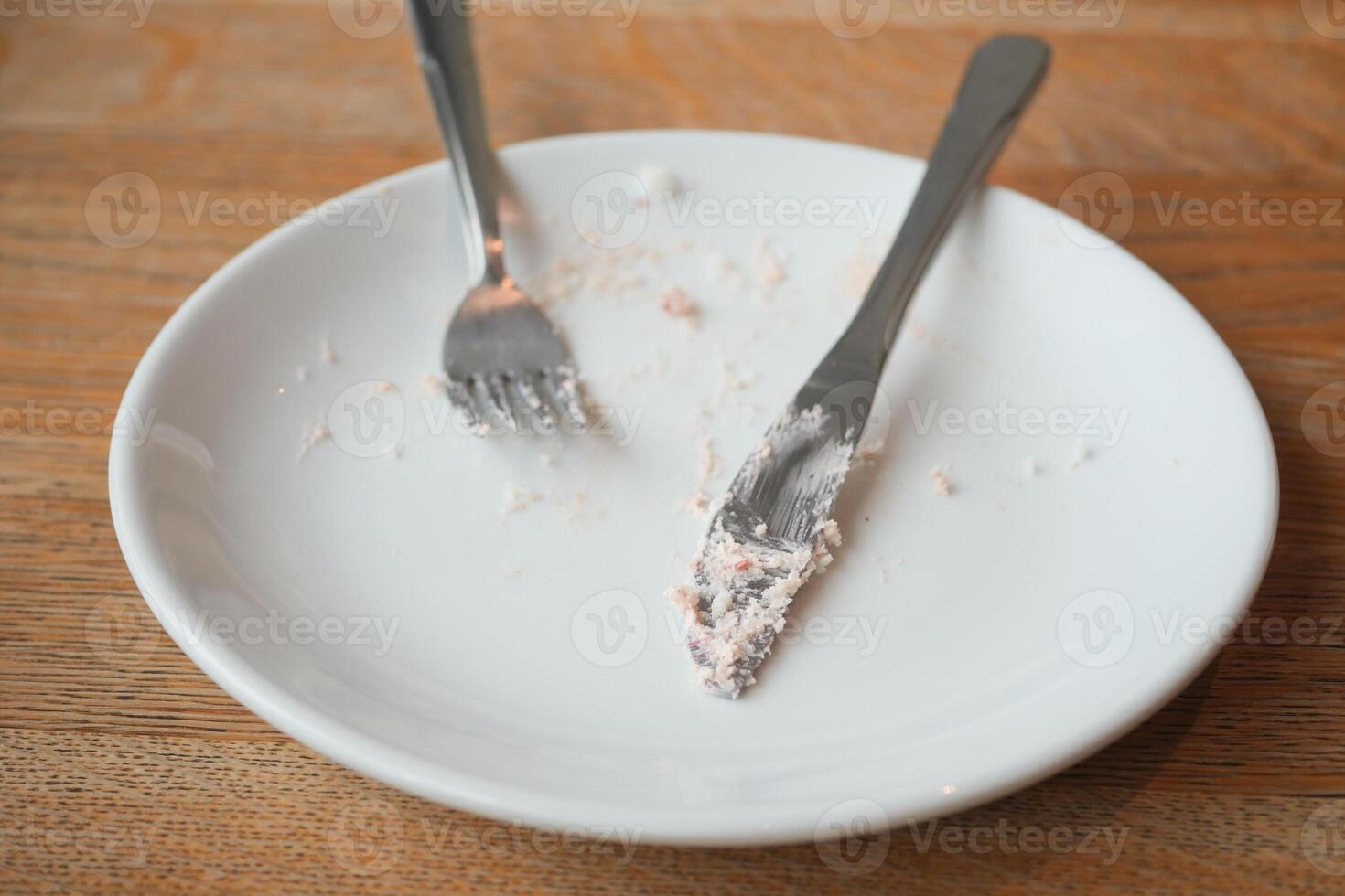 Dessert plate with remnants of cake after a delightful meal photo