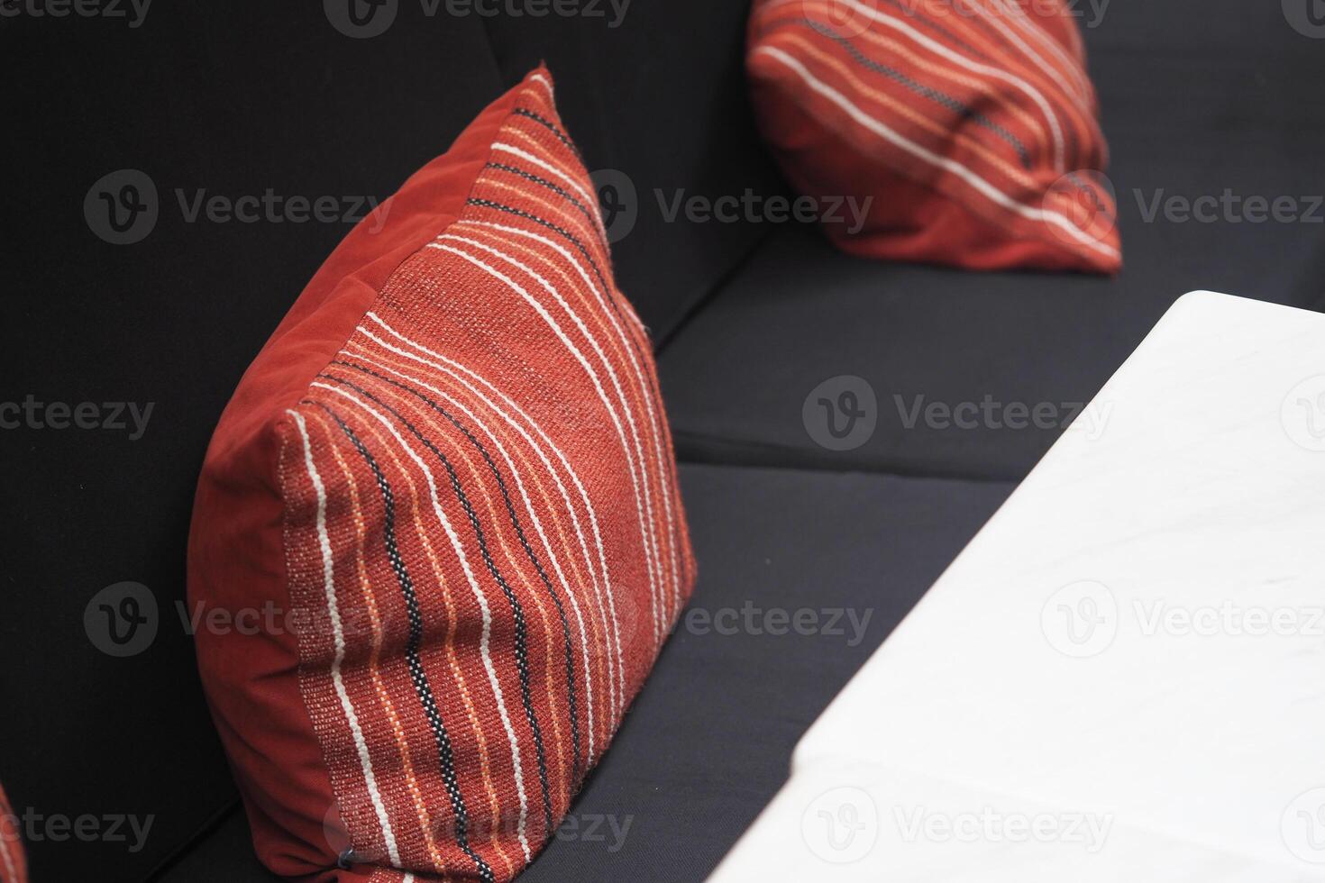Cozy seating area with striped cushions and marble table photo