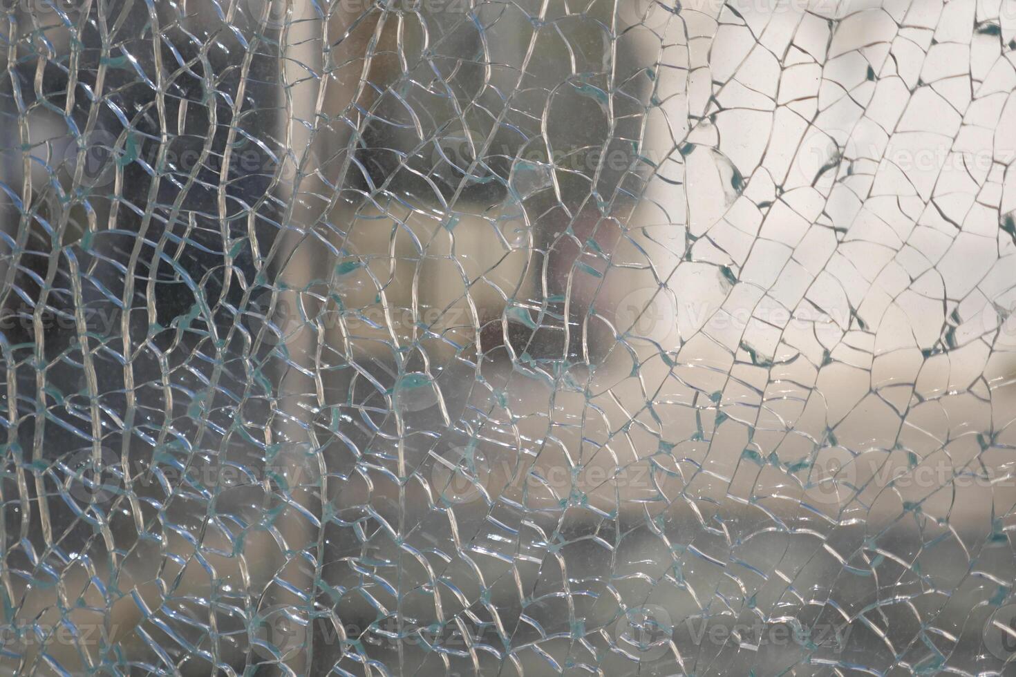 Shattered glass displaying intricate patterns in bright light photo