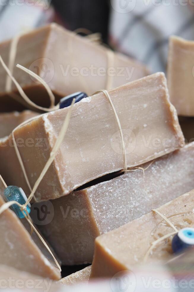 Natural handmade soap displayed in a market during daytime photo