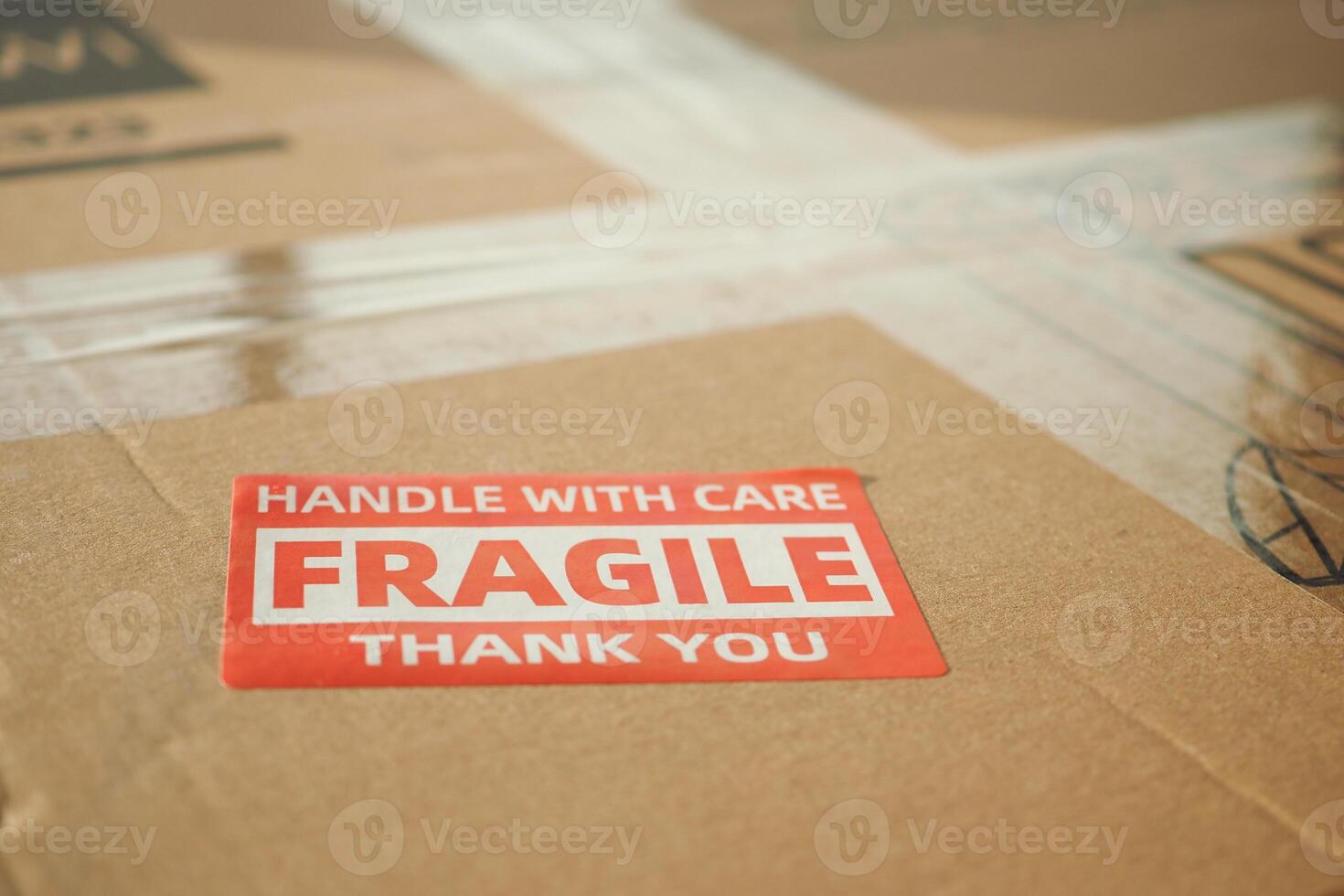 Box labeled fragile handled with care at a shipping facility photo