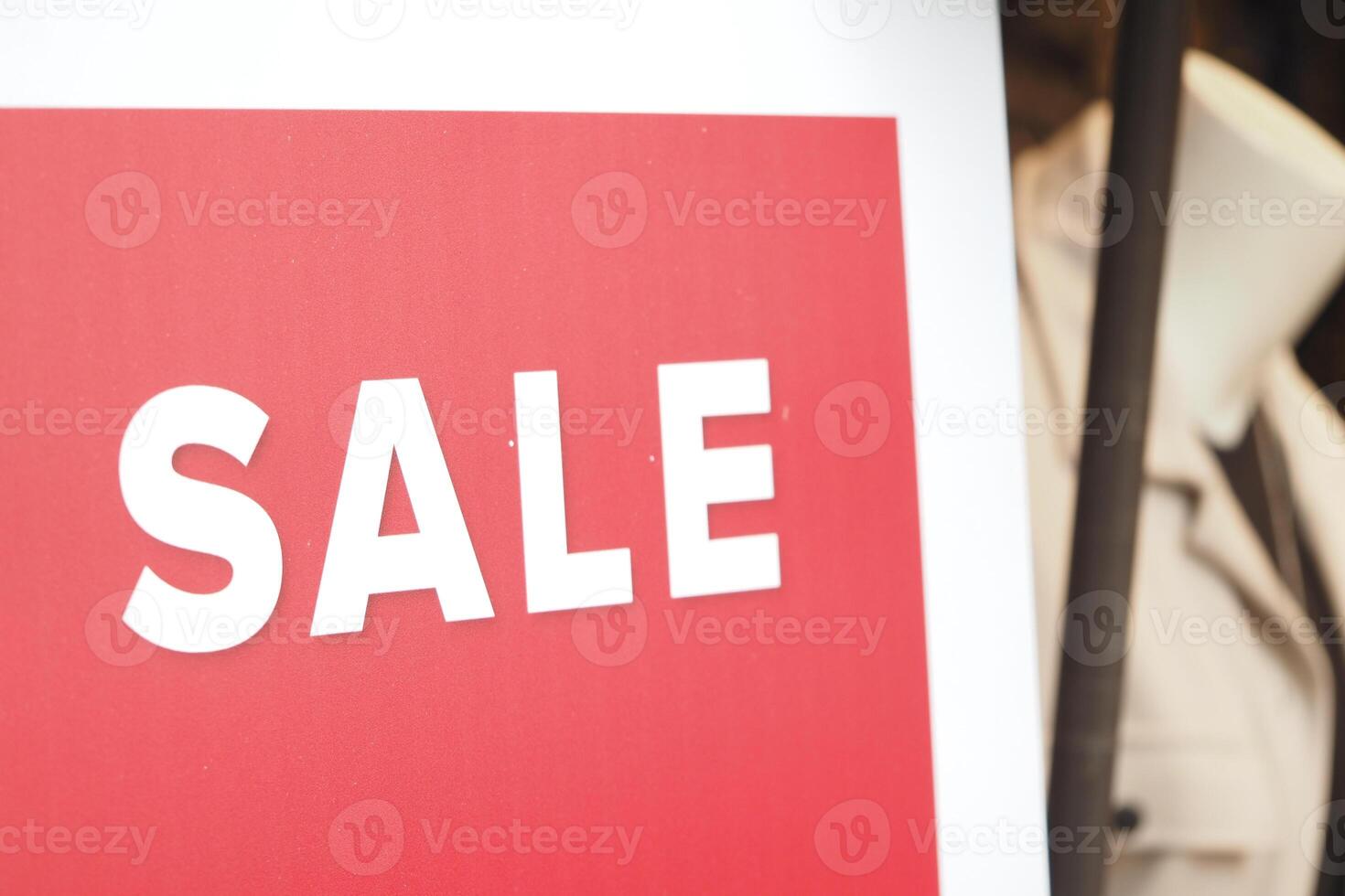 Big sale sign displayed in clothing store window during daytime photo