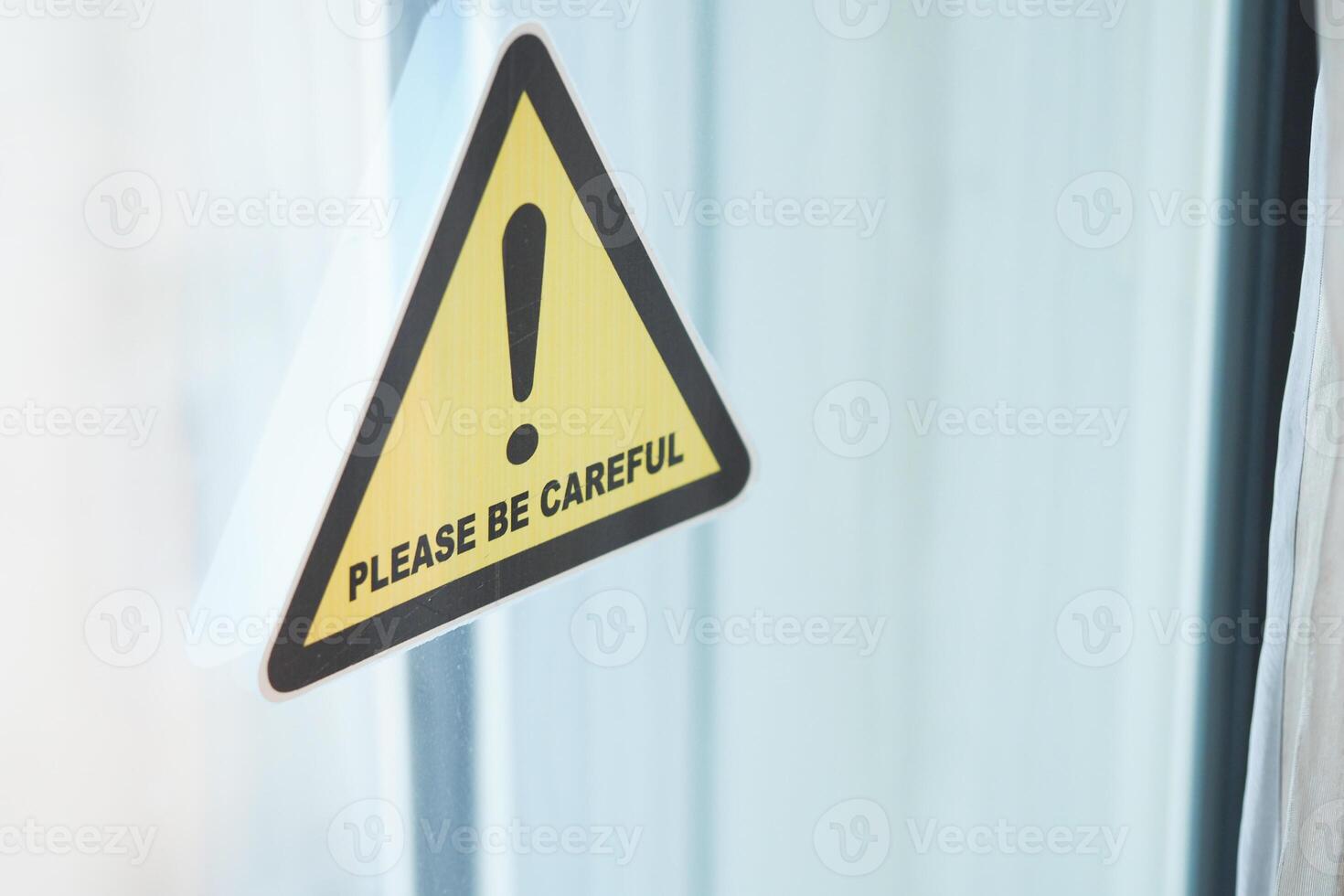 Caution sign urging attention in indoor setting photo