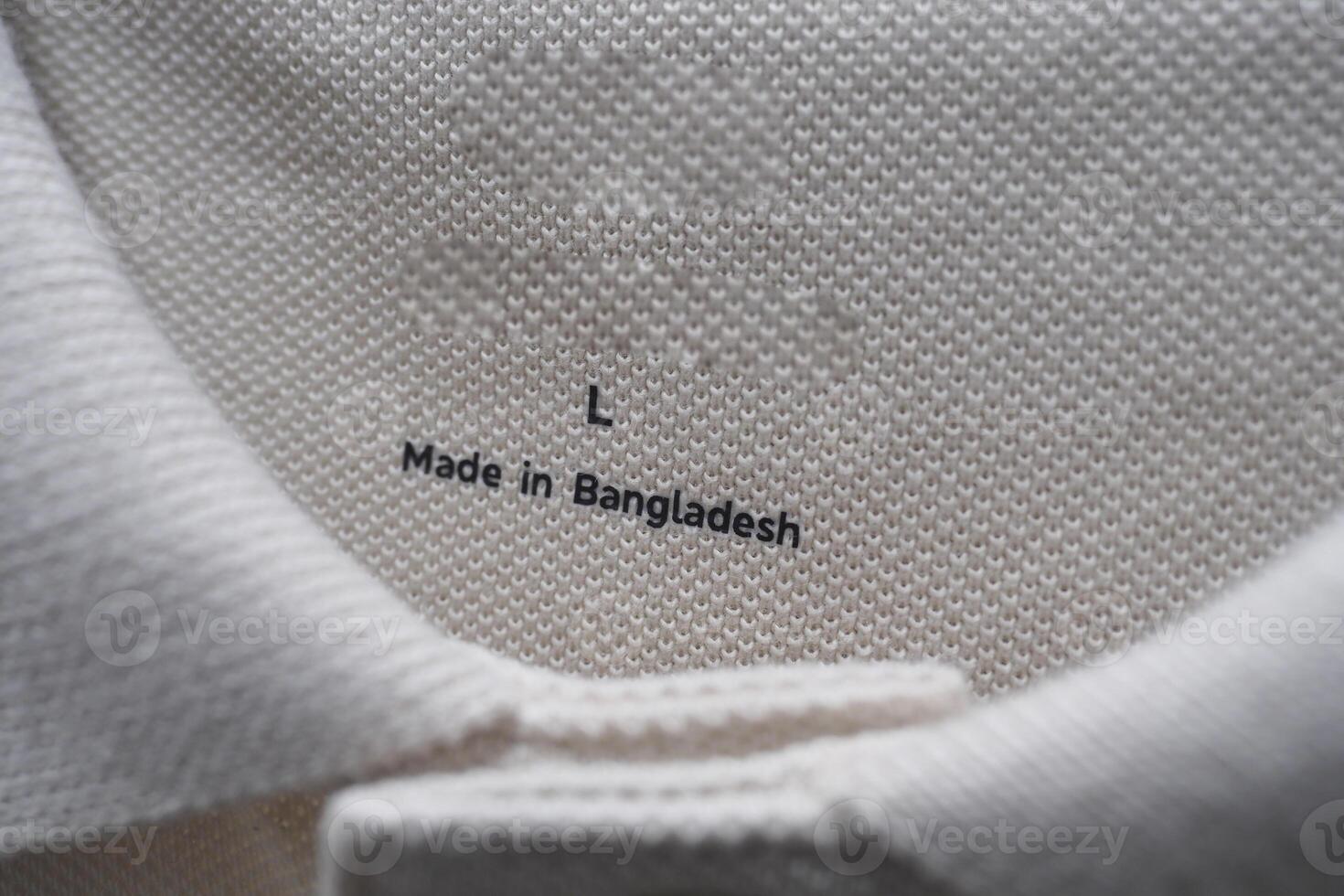 Tag showing size and origin on a garment from Bangladesh photo
