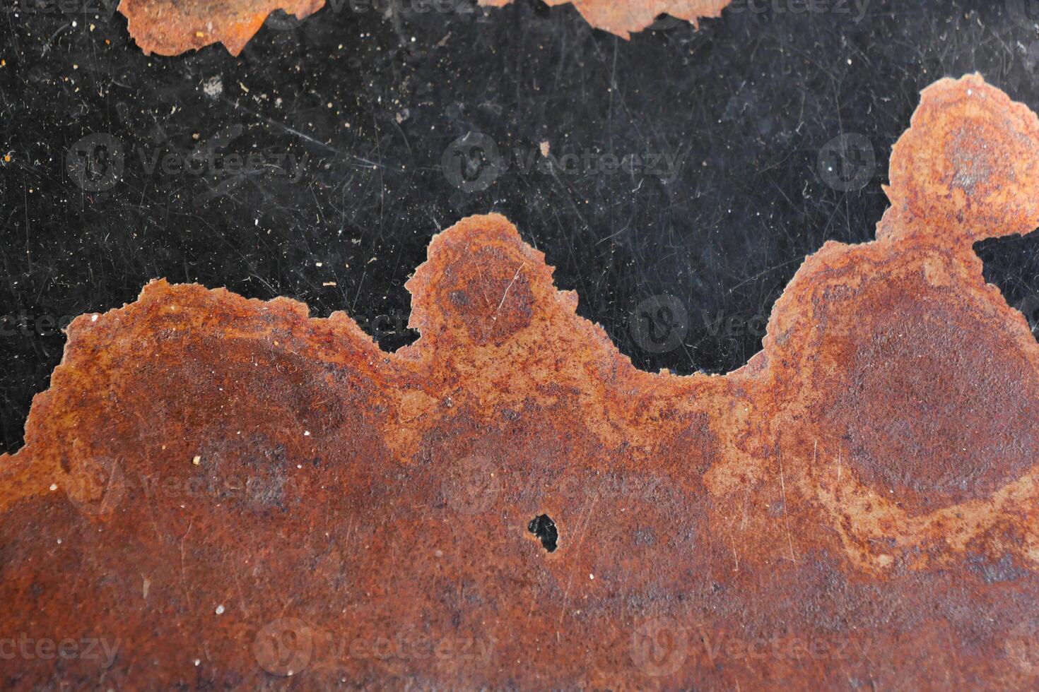 Rusty metal surface revealing a textured, weathered pattern photo