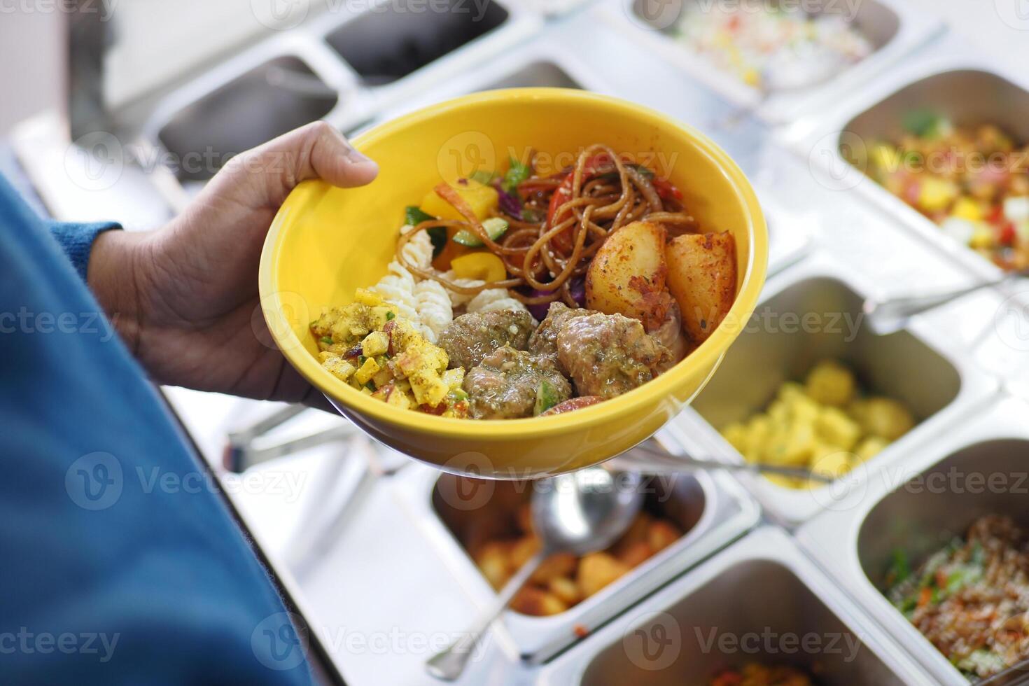 Colorful bowl of curry and vegetables at a buffet photo