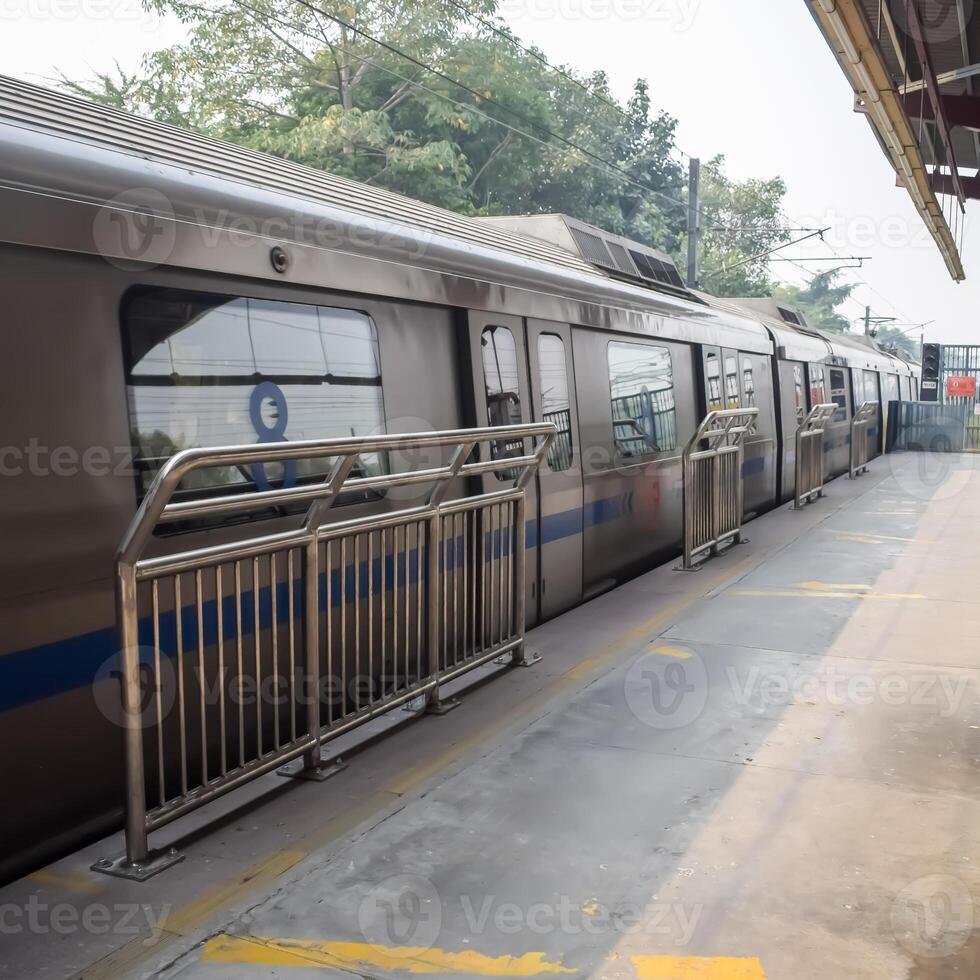 A train is parked at a station with a platform photo