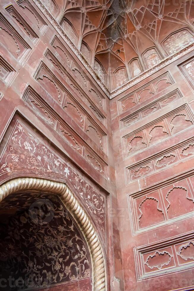 The intricate carvings on the walls of the red fort photo