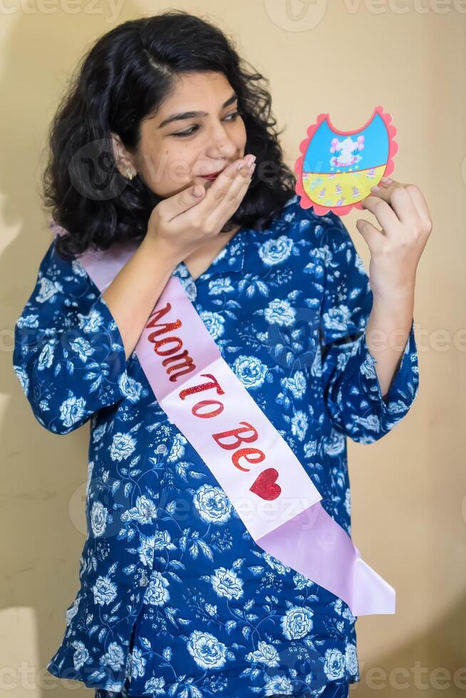 A woman holding a sash and a piece of paper photo