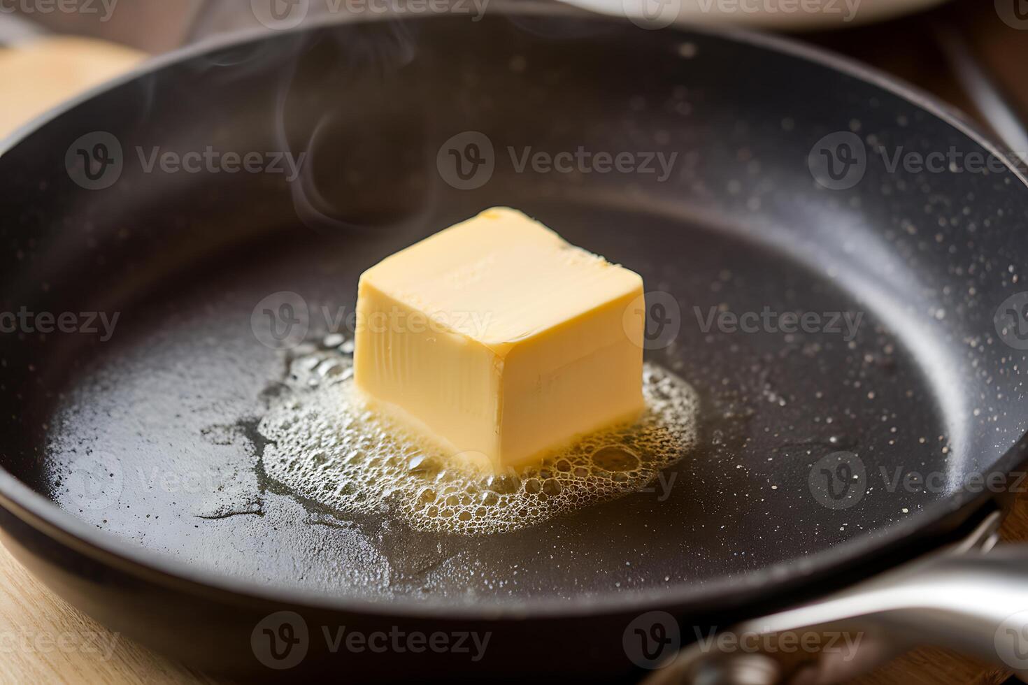 A block of butter is being fried in a pan photo