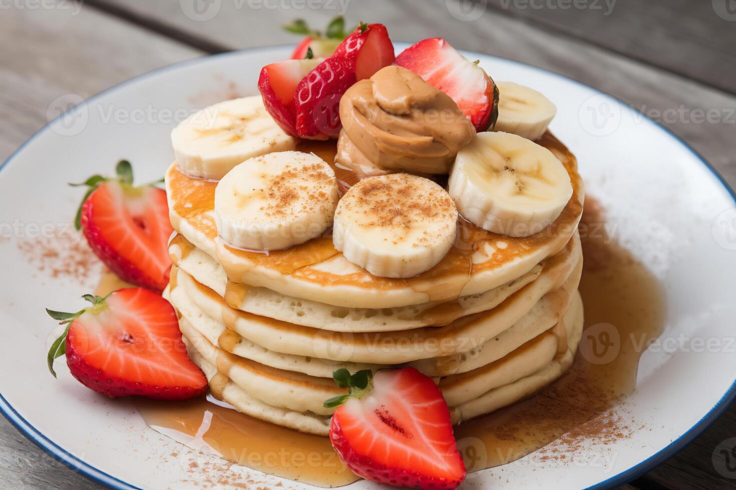 A stack of pancakes with strawberries and bananas photo