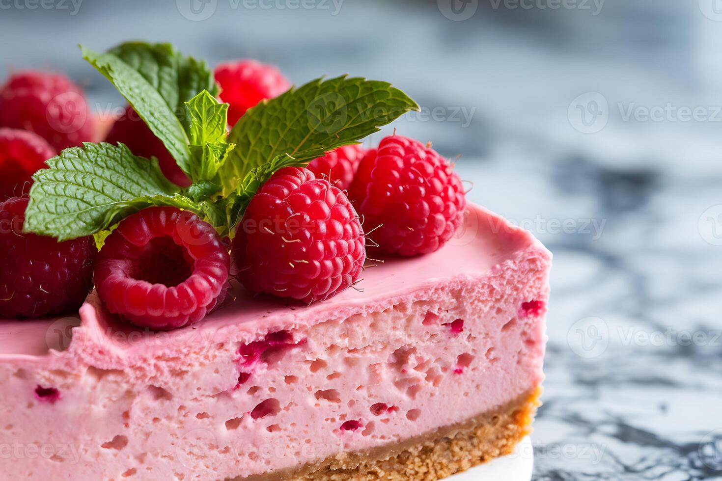 A piece of cheesecake with raspberries on top photo
