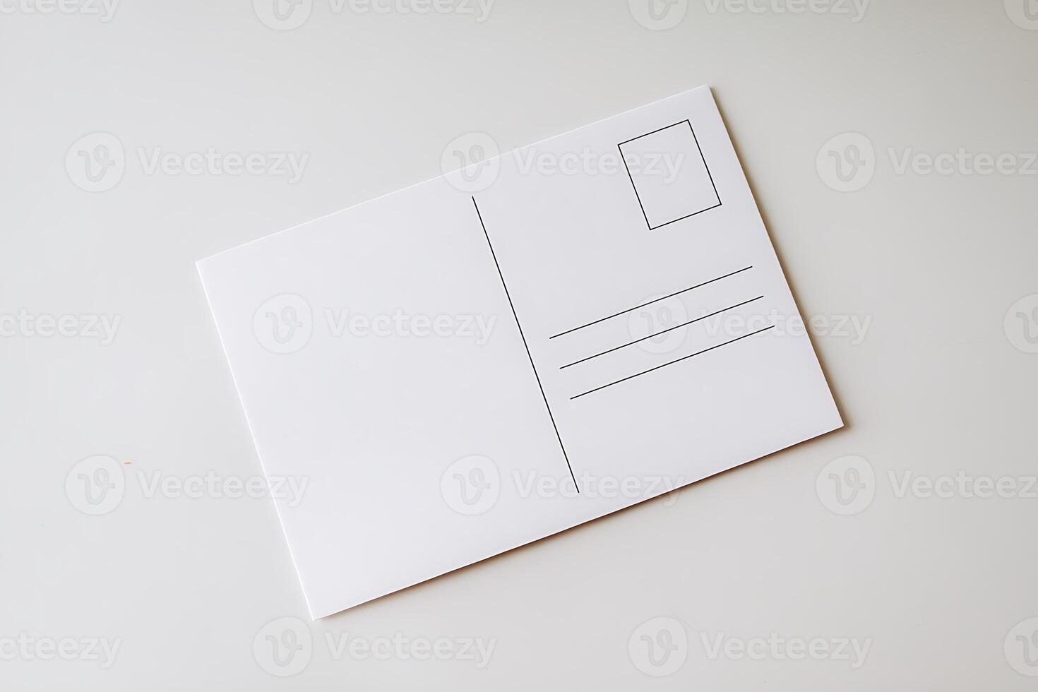 A white envelope with a postcard on top photo