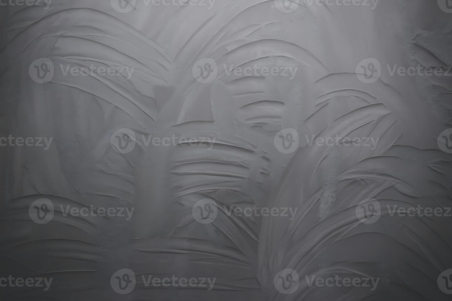 A black and white photo of a wall with a pattern of leaves