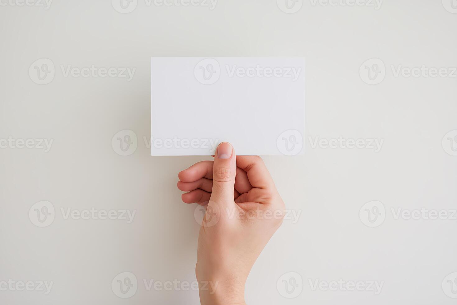 A person holding up a blank piece of paper photo