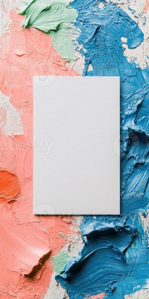 Artistic flat lay with empty white card on colorful paint background for creative design photo