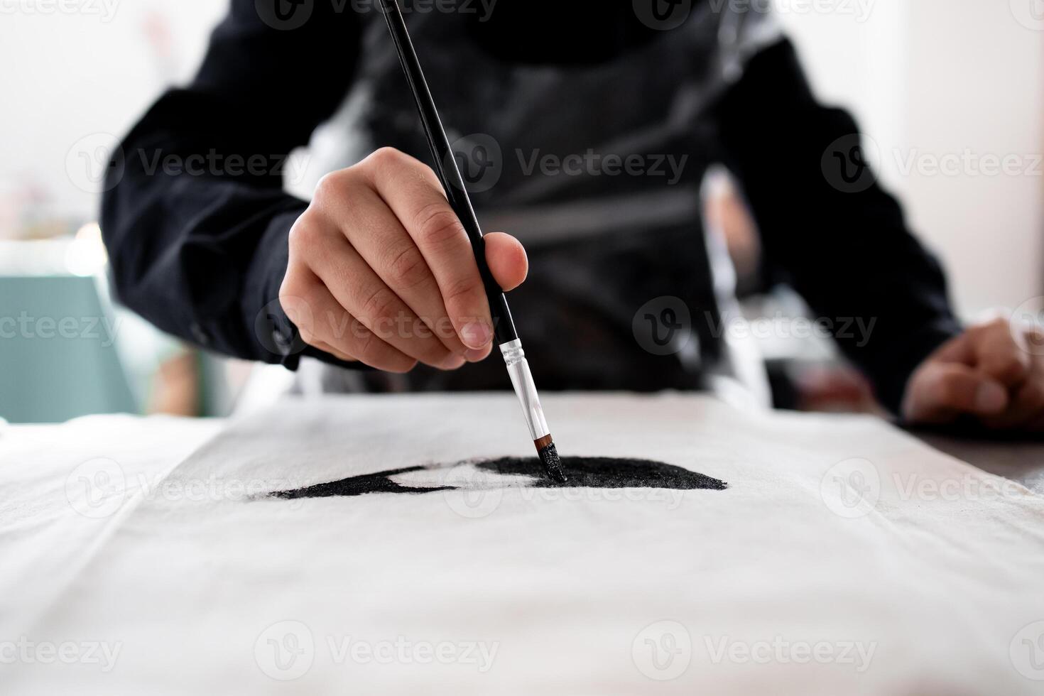 Close up of artistic hand painting on fabric with precision and skill photo
