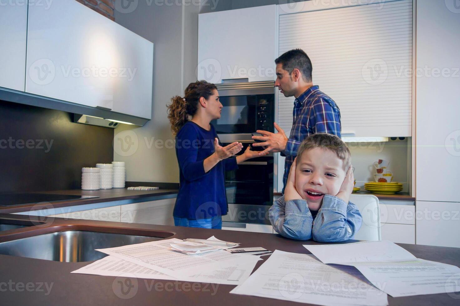 A man and woman in a kitchen with a child photo