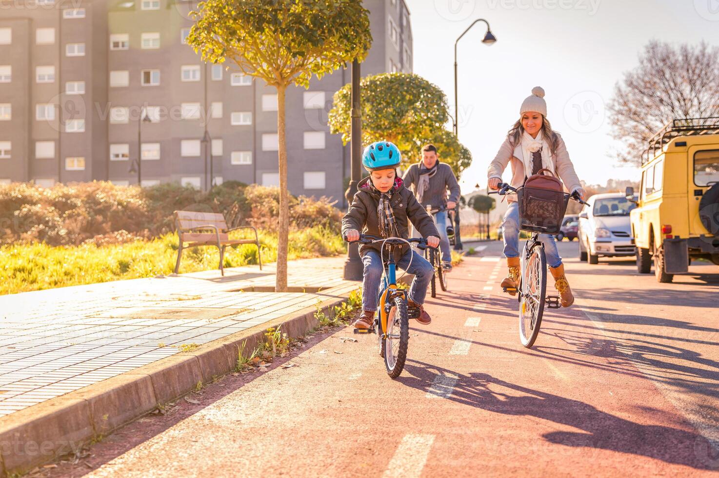 Family with child riding bicycles in the city photo