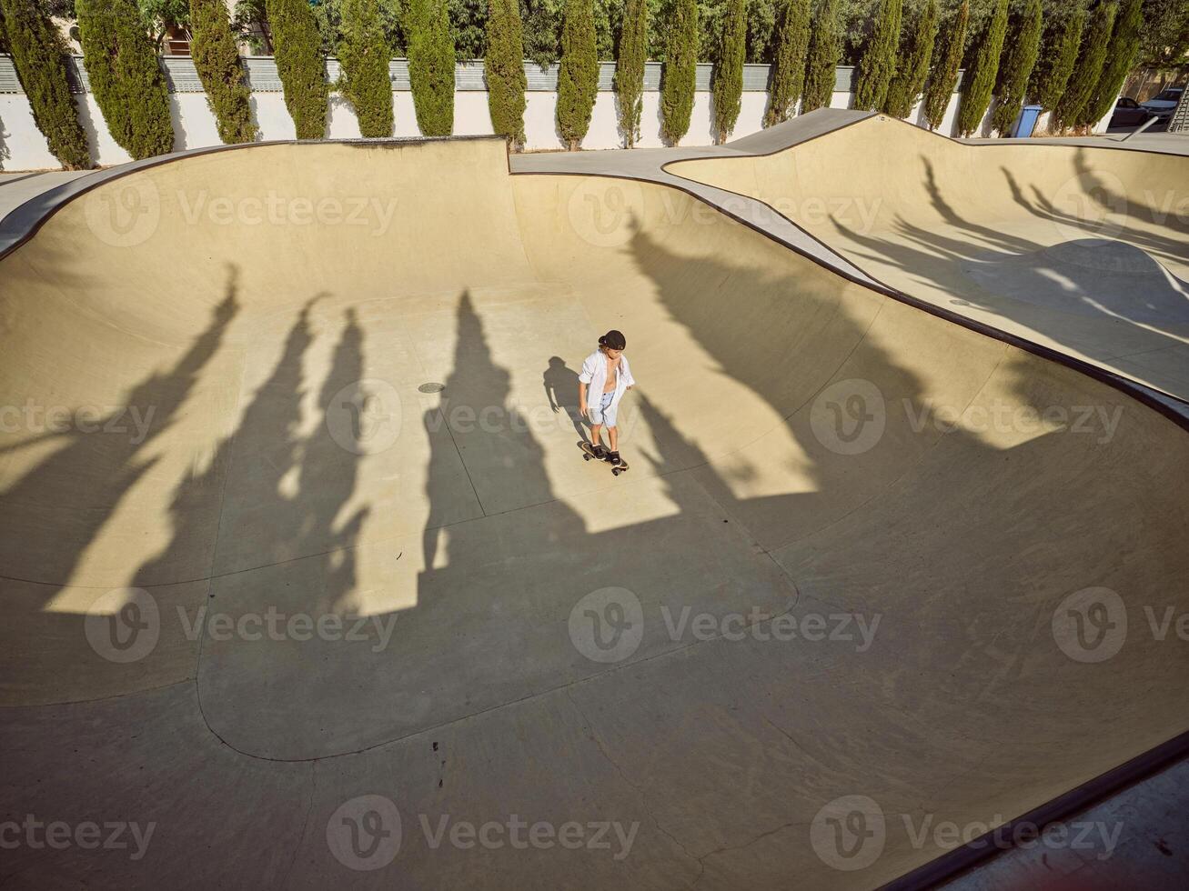 A young skateboarder riding a ramp at a skate park. photo