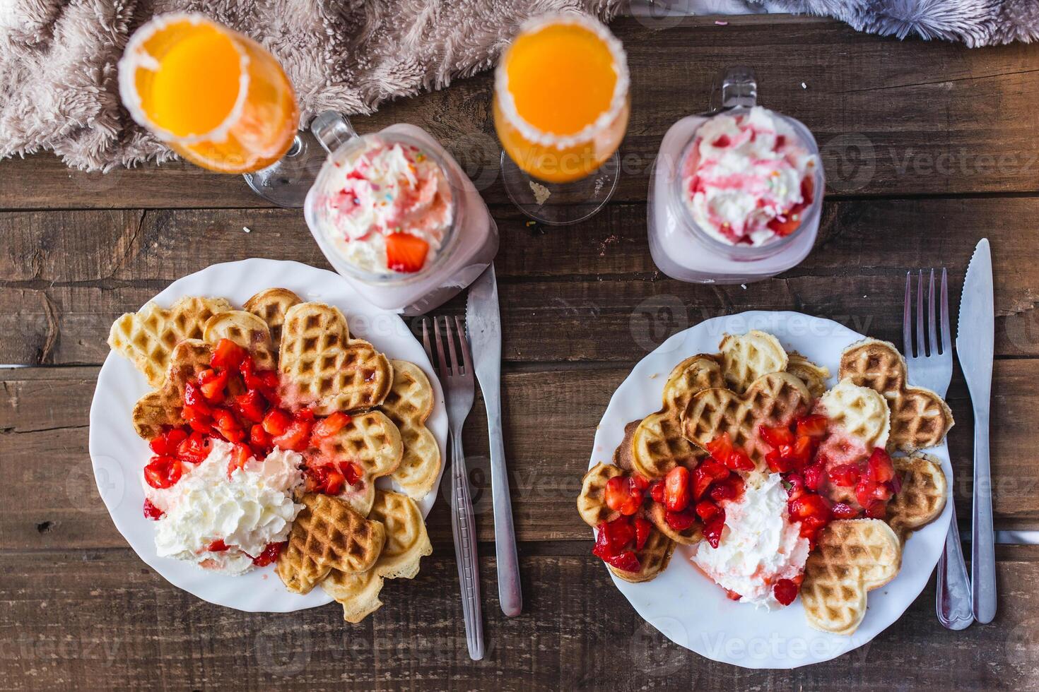 Appetizing waffles with jam and tasty drinks on tray on bed photo