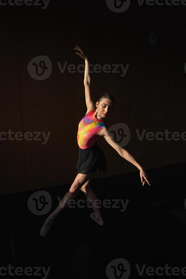 A woman in a colorful dress is doing a dance photo