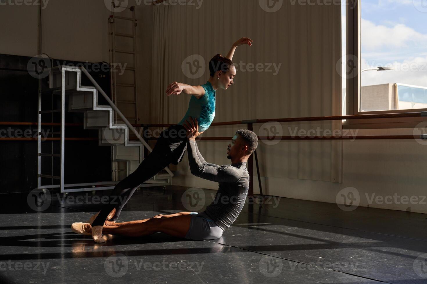 A man and woman practicing in a dance studio photo