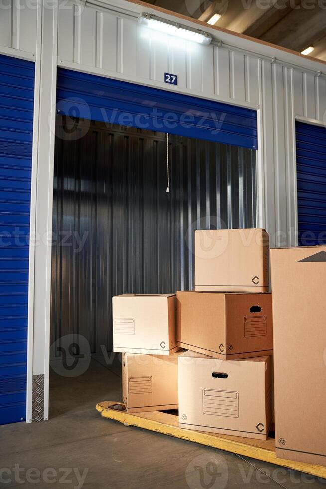 A storage unit with boxes and a door photo