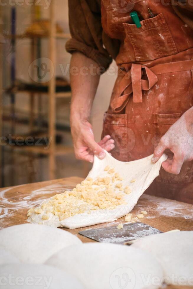A man is making dough on a table photo