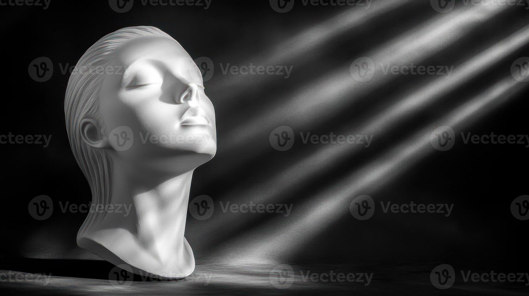 A serene white sculpture illuminated by soft, dramatic light. photo